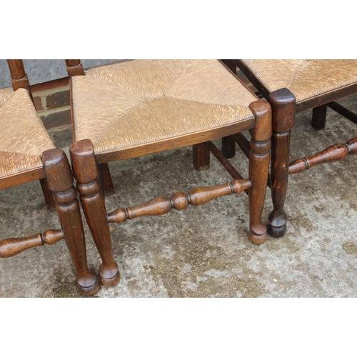 667 - A closely matched set of eight oak rush seat ladderback dining chairs, on turned and stretchered sup... 