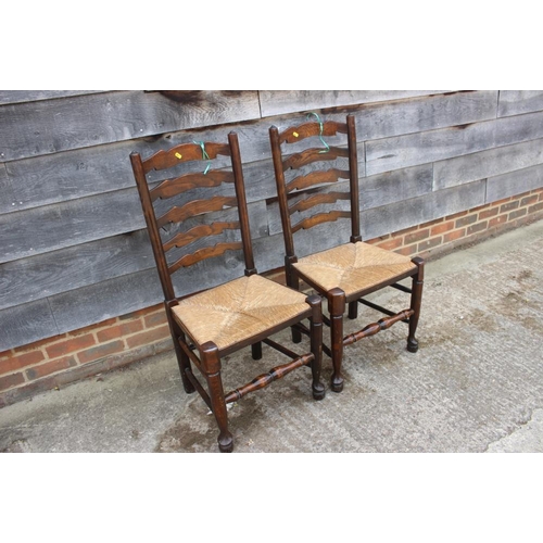 667 - A closely matched set of eight oak rush seat ladderback dining chairs, on turned and stretchered sup... 