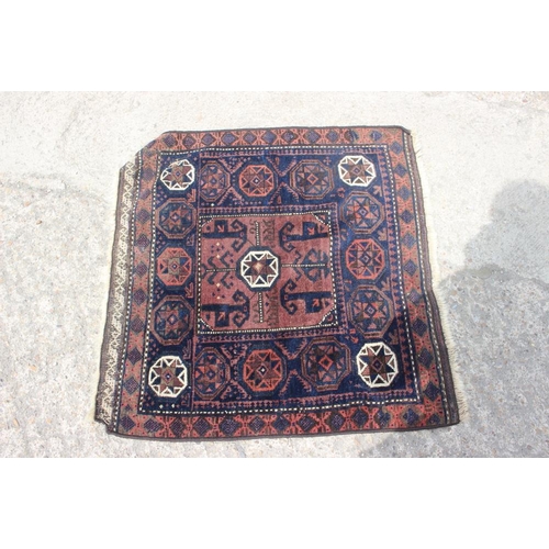 758 - A Caucasian rug with star designs and central square medallion in shades of cream and terracotta on ... 