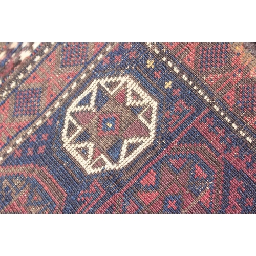 758 - A Caucasian rug with star designs and central square medallion in shades of cream and terracotta on ... 