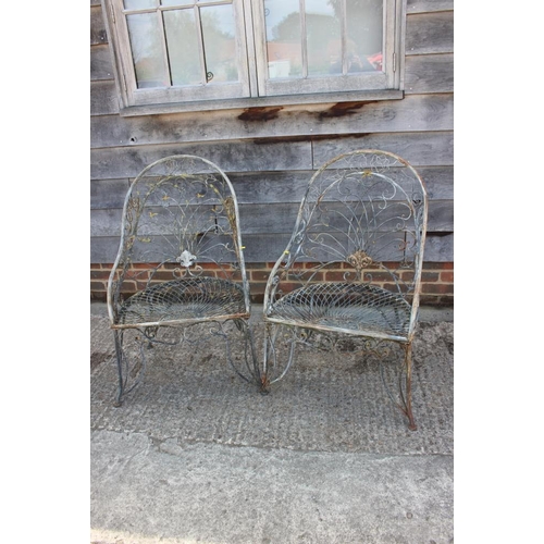 776 - A pair of Art Nouveau design wrought metal tub-shape garden armchairs, on scroll supports