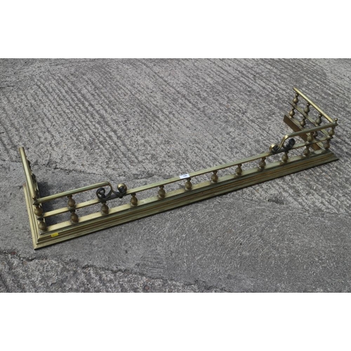 192 - A Victorian brass rail fender, 54