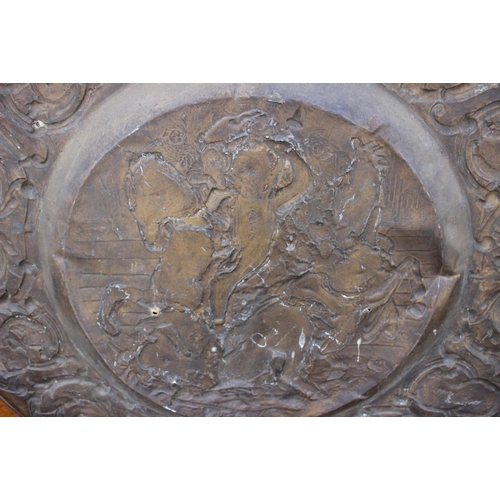 200 - A circular embossed copper plaque, traces of gilding, centre with Battle of Anghiari after Leonardo,... 