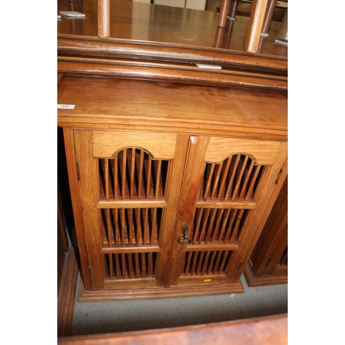 658 - A pair of Indonesian teak cupboards enclosed two spindle decorated doors, 26