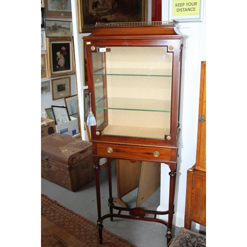 546 - An Edwardian mahogany gallery top display cabinet enclosed single glazed door over one drawer, on tu... 