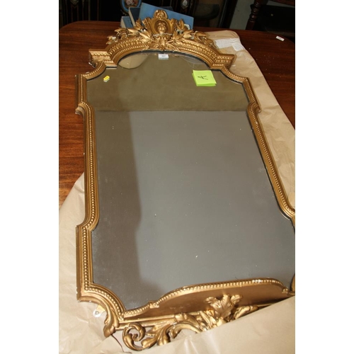 607 - A shaped gilt framed wall mirror with shelf below and paste crest, 26