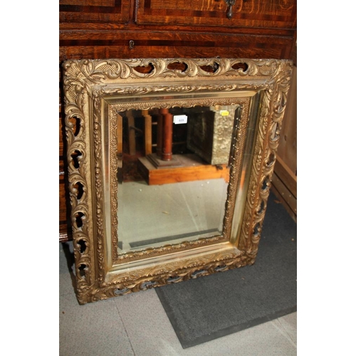 609 - A pierced gilt framed wall mirror with bevelled plate, 19