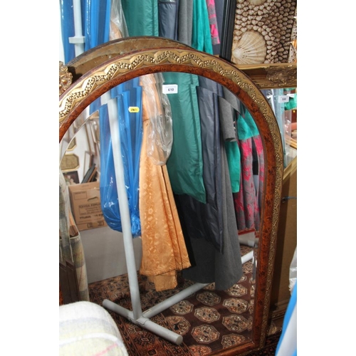 610 - An Art Deco design burr walnut finish and gilt decorated wall mirror, arched top plate 25