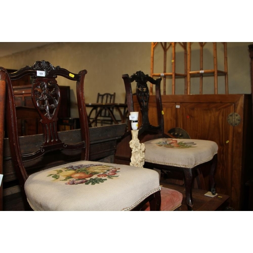 620 - A pair of Edwardian carved mahogany low seat saloon chairs with needlepoint upholstery, on cabriole ... 