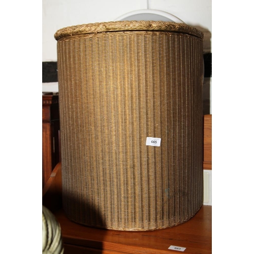 665 - A Lloyd Loom semicircular linen box with original gold paint finish