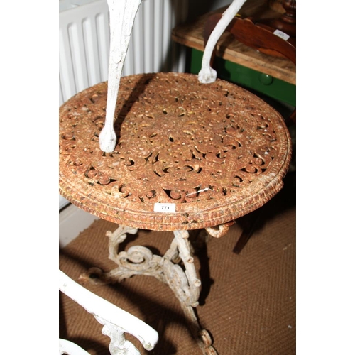 771 - A cast iron and painted circular garden table with pierced decoration and tripod supports, 24