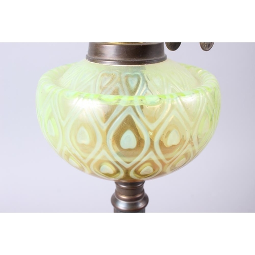 303 - An oil lamp with etched decoration, vaseline coloured glass chamber and fluted brass column, on ebon... 