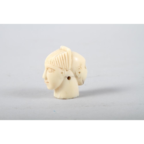 134 - An ivory cane handle, formed as two heads, 2