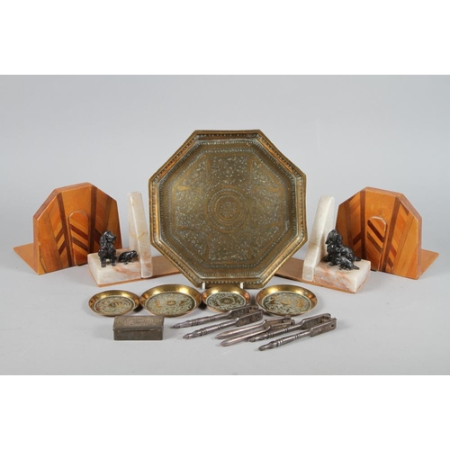 240 - An Indian engraved brass octagonal tray and smaller similar pin trays, three nut cracks, a Bell & Co... 