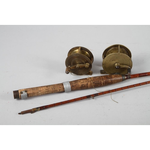 191 - A split cane fishing rod, an Alcock & Co brass reel and one other brass reel SENT TO CHARITY