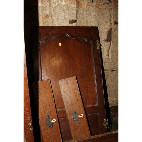 517 - An 18th century oak wardrobe, the upper section enclosed two Gothic panel doors over two faux drawer... 