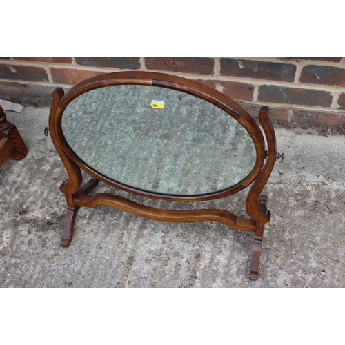 558 - A mahogany and oak oval swing frame mirror, on skeleton stand, 20 1/2