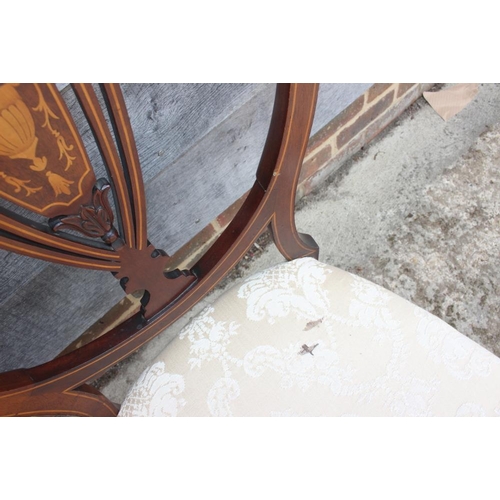 590 - Three mahogany and string inlaid shield back side chairs, upholstered in a cream brocade, on turned ... 