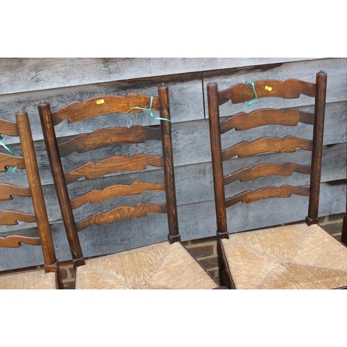 595 - A closely matched set of eight oak rush seat ladderback dining chairs, on turned and stretchered sup... 