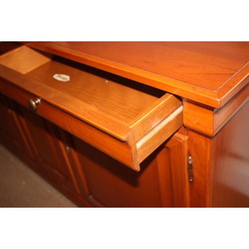 603 - A Selva cherrywood sideboard, fitted three drawers over three cupboards enclosed panelled doors, on ... 