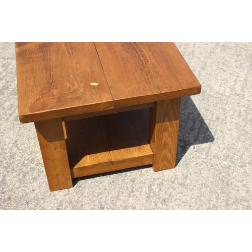 683 - A dark waxed pine two-tier coffee table, 36