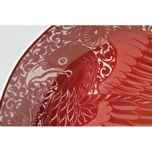 11 - A William de Morgan red lustre charger, decorated eagle and snake, 14