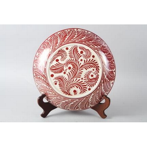 11 - A William de Morgan red lustre charger, decorated eagle and snake, 14