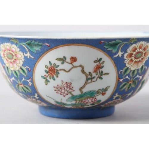 113 - A Chinese famille rose bowl, decorated panels with various flowers on a blue textured glazed ground,... 