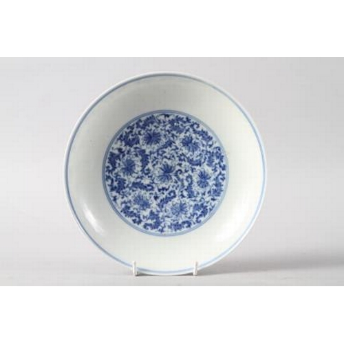 114 - A Chinese blue and white dish with scrolled and floral decoration and seal mark to base, 8