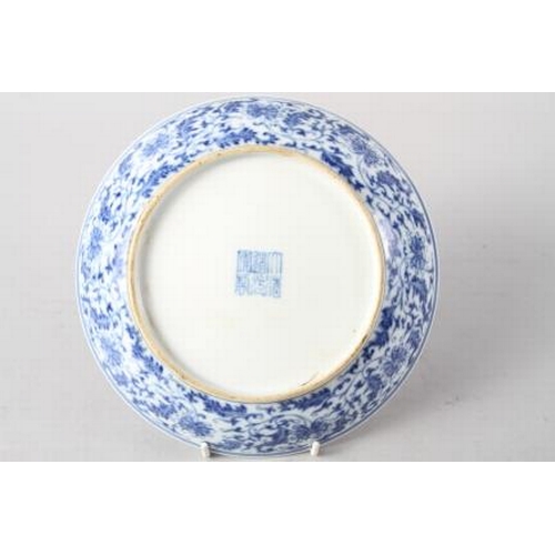 114 - A Chinese blue and white dish with scrolled and floral decoration and seal mark to base, 8