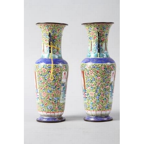 123 - A pair of Chinese Canton enamel cloisonne vases with panels decorated figures on a floral pattern ye... 