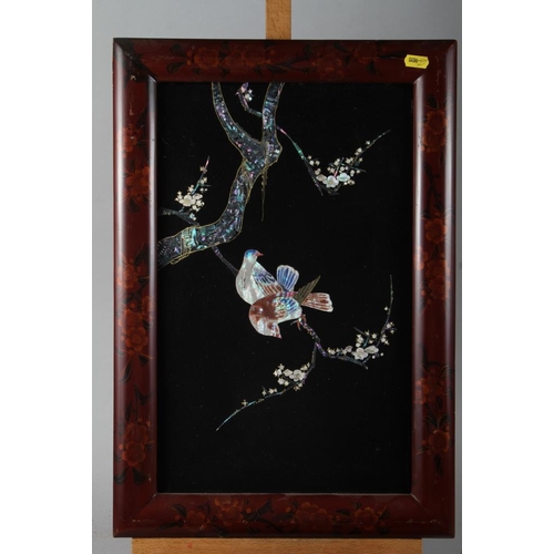 129 - A pair of Oriental ebonised panels of birds on branches with inset mother-of-pearl and abalone, in l... 