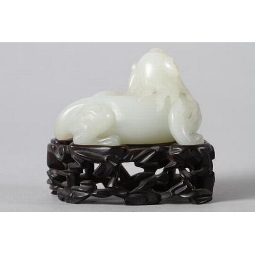 135 - A Chinese carved jade mythical beast, on hardwood stand, 3