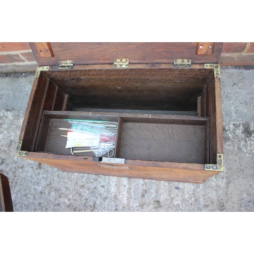 167 - A craftman's 19th century oak workbox with two sliding trays and wrought iron carry handles, 20