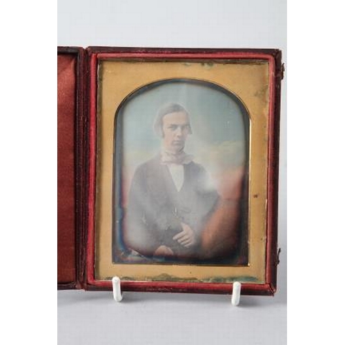 212 - A tinted quarter plate daguerreotype of a gentleman, in folding morocco case (slight edge oxidisatio... 