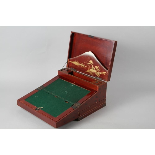 232 - A Japanese lacquered writing box with inset bone decoration in the form of an eagle, 12