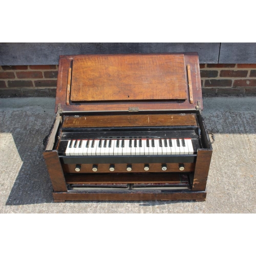 239 - A walnut cased portable seven stop organ/harmonium, in fitted case