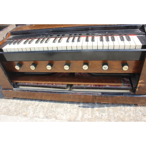 239 - A walnut cased portable seven stop organ/harmonium, in fitted case