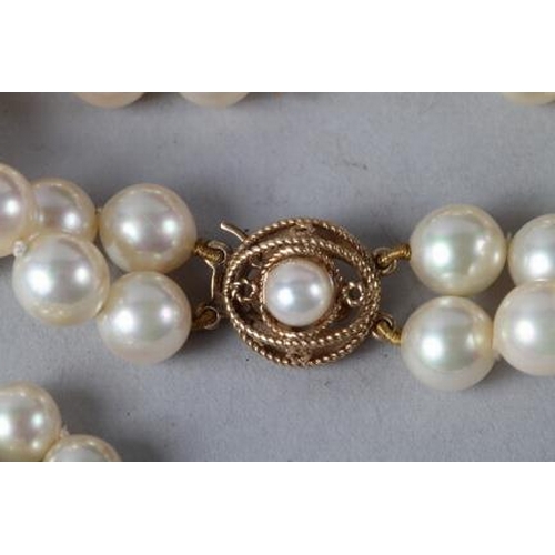 339 - A cultured pearl necklace with 9ct gold clasp, a matching bracelet and two other pearl necklaces