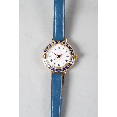 351 - A lady's 15ct gold cased wristwatch with enamelled bezel and dial with Roman numerals