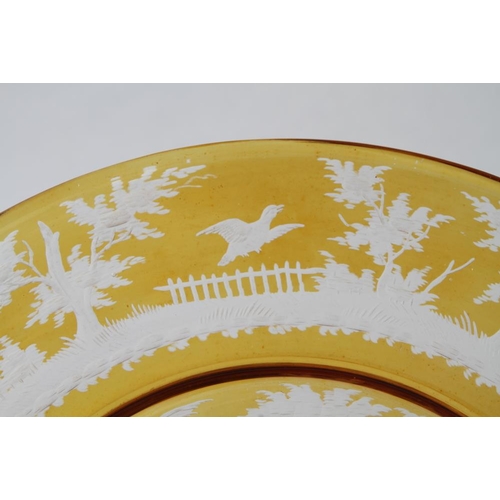 45 - A 19th century Bohemian yellow flashed and engraved plate with rutting stags design, 10 3/4