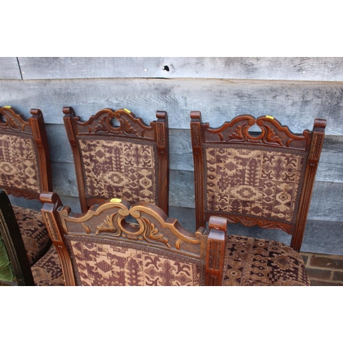 510 - A set of four late 19th century carved walnut side chairs with padded seats and backs, on turned and... 