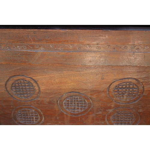 525 - An 18th century chip carved two panel front coffer, on stile supports, 42