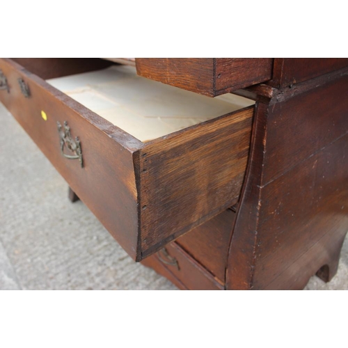 534 - An early 19th century Continental oak bombe-shape fall front bureau, the upper section fitted drawer... 