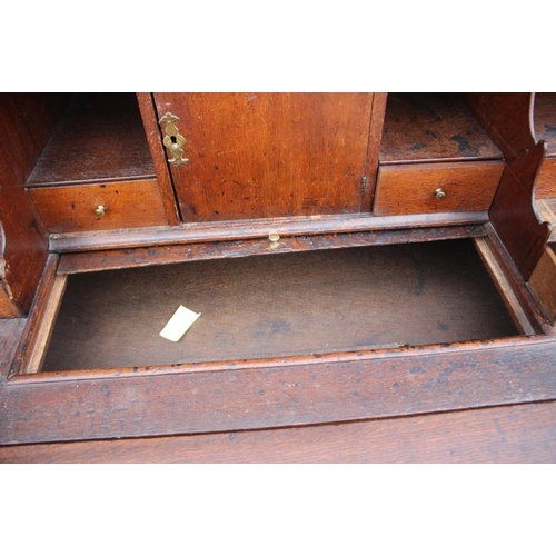 534 - An early 19th century Continental oak bombe-shape fall front bureau, the upper section fitted drawer... 