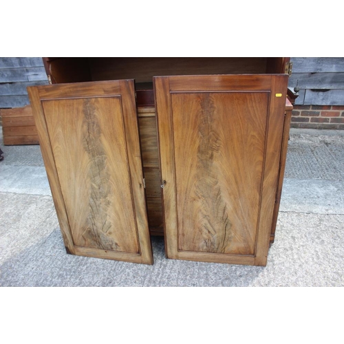 541 - A 19th century figured mahogany linen press, the upper section fitted pull-out trays enclosed two pa... 