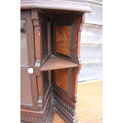 543 - A late 19th century oak and walnut corner hanging cabinet enclosed lattice glazed door, 20