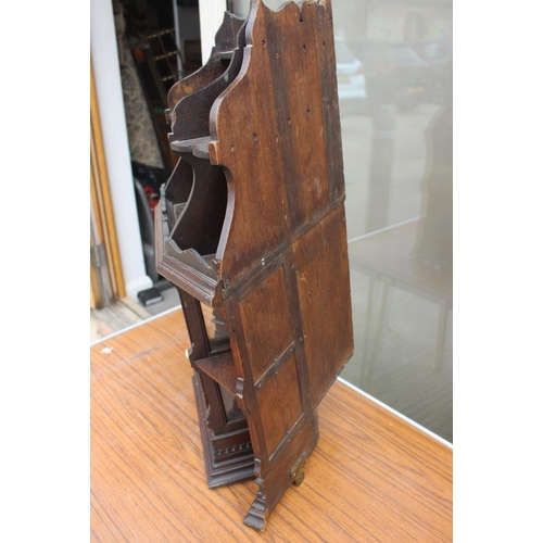 543 - A late 19th century oak and walnut corner hanging cabinet enclosed lattice glazed door, 20