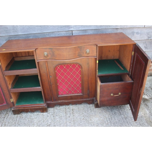 548 - A late 19th century mahogany break serpentine front sideboard, fitted centre drawer and three cupboa... 