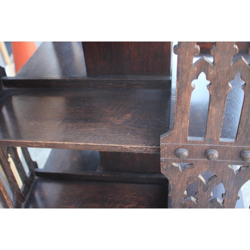 550 - A late Victorian carved oak three-tier revolving bookcase with Gothic pierced sides, 25